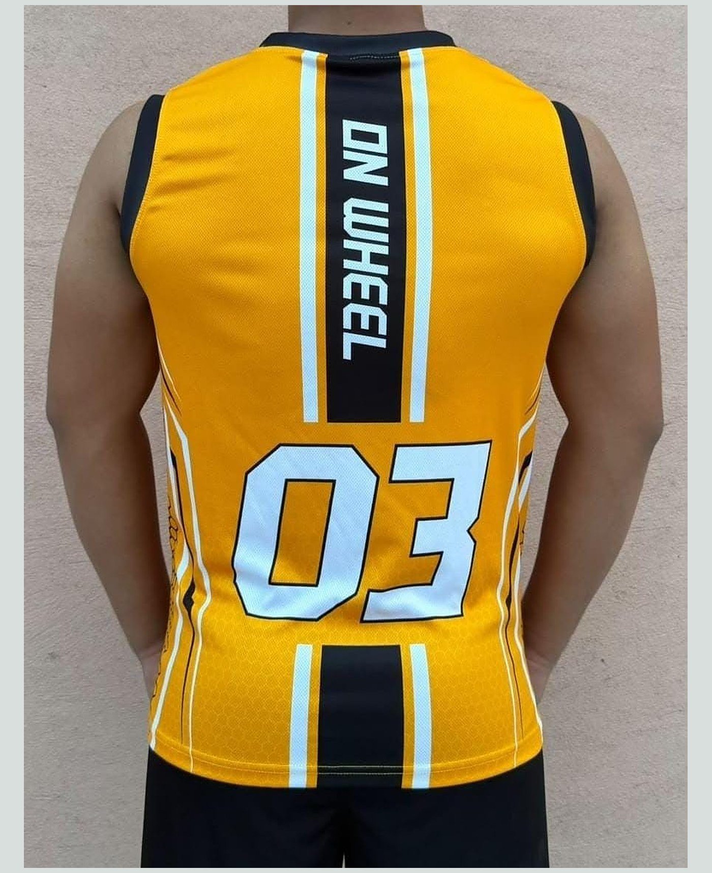 Custom match vest, back — gold / black, squad number and name — our own range — On Wheel International, Sialkot